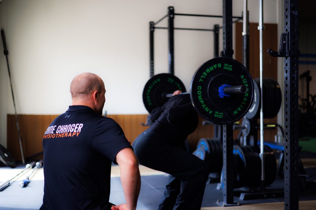Physiotherapist coaching an athlete through a lift at New Movement Gym, Osborne Park
